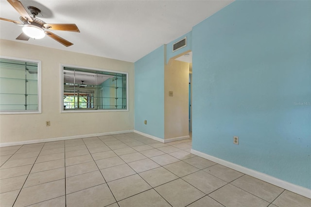 empty room with ceiling fan and light tile patterned flooring