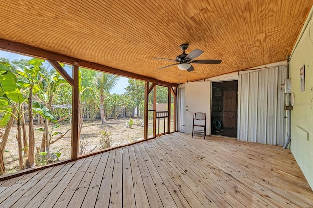 unfurnished sunroom with ceiling fan and wooden ceiling