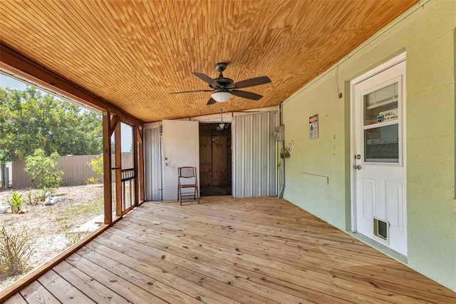 unfurnished sunroom with ceiling fan and wooden ceiling