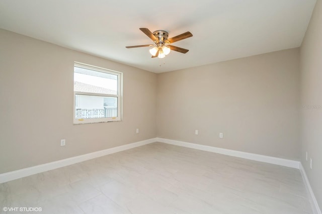 tiled spare room featuring ceiling fan