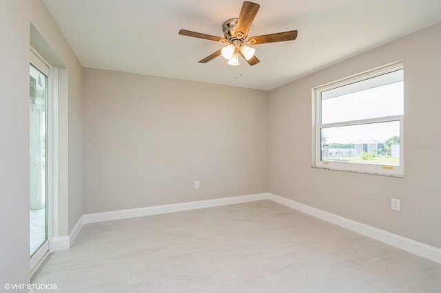 spare room with ceiling fan and light tile flooring