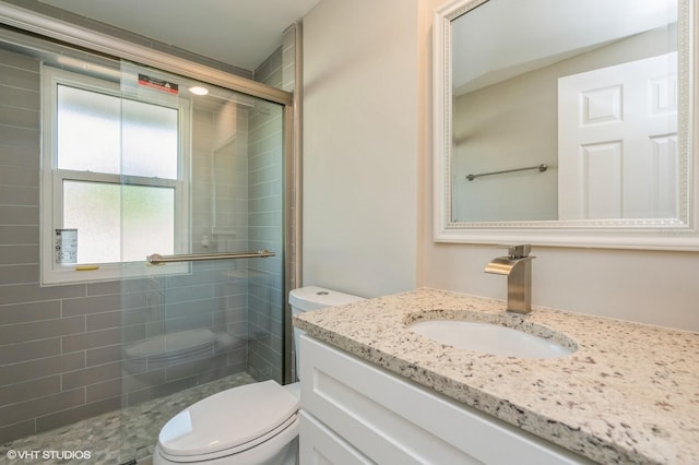 bathroom with an enclosed shower, toilet, and vanity