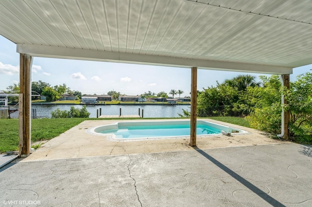 view of pool with a water view, a lawn, and a patio area