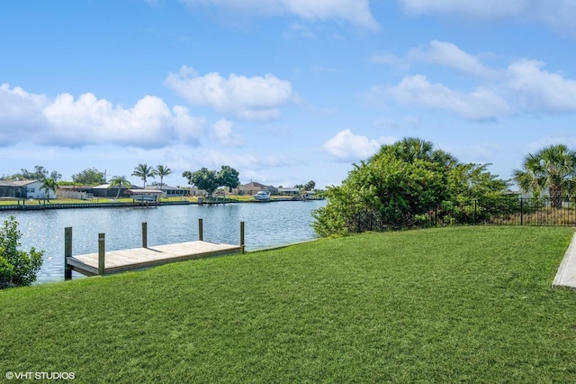 view of dock featuring a yard and a water view