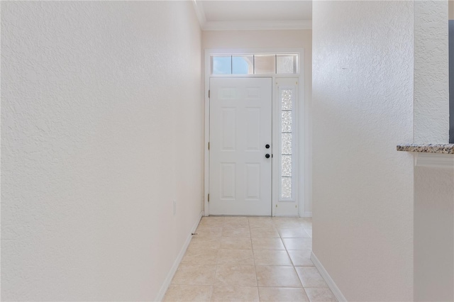 tiled foyer entrance with crown molding