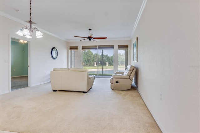 living room featuring ornamental molding, ceiling fan with notable chandelier, and carpet flooring