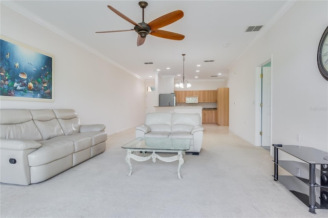 carpeted living room featuring ceiling fan and ornamental molding