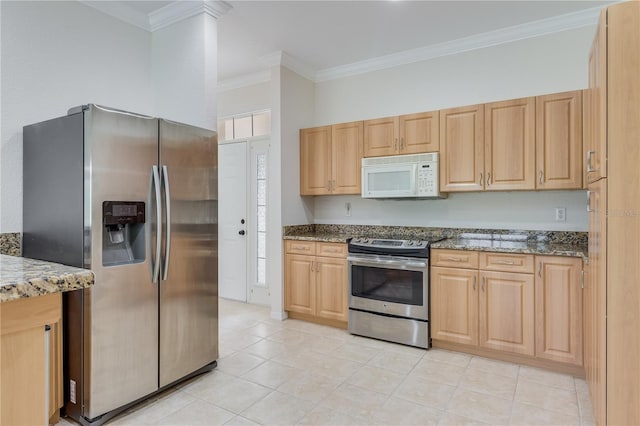 kitchen featuring appliances with stainless steel finishes, crown molding, dark stone counters, and light tile floors