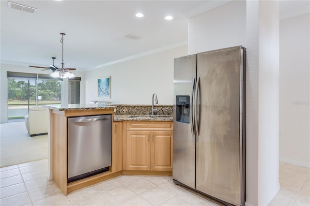 kitchen featuring light stone countertops, stainless steel appliances, sink, ceiling fan, and light brown cabinetry