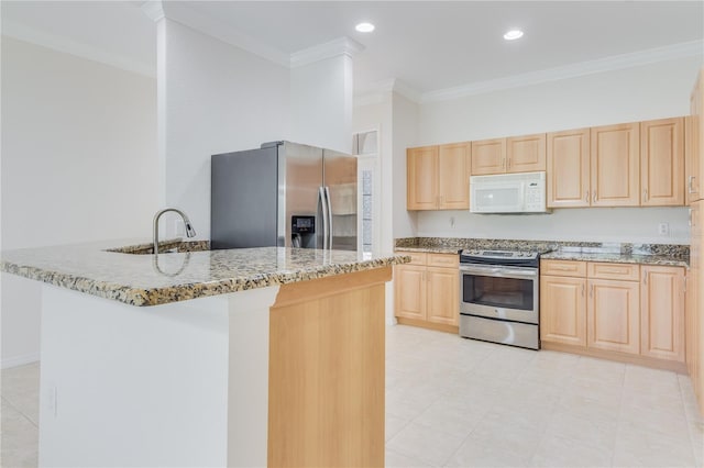 kitchen with appliances with stainless steel finishes, light tile flooring, and light brown cabinetry