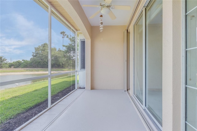 unfurnished sunroom featuring ceiling fan