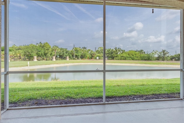 unfurnished sunroom with a water view