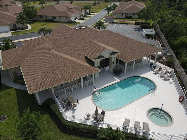 view of pool featuring a lawn, a hot tub, and a patio