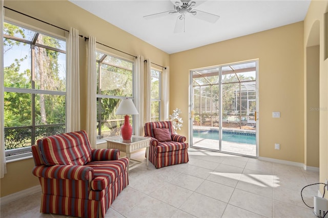 sitting room featuring ceiling fan and light tile floors