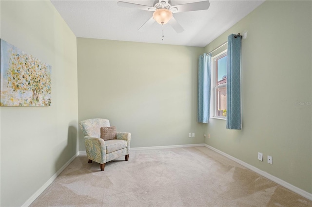 living area with carpet flooring and ceiling fan