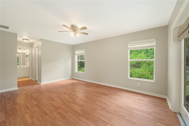 unfurnished room with ceiling fan and light wood-type flooring