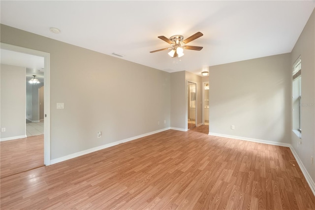 tiled empty room featuring ceiling fan