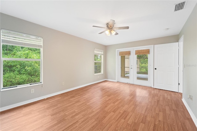 empty room featuring light hardwood / wood-style floors, french doors, and ceiling fan