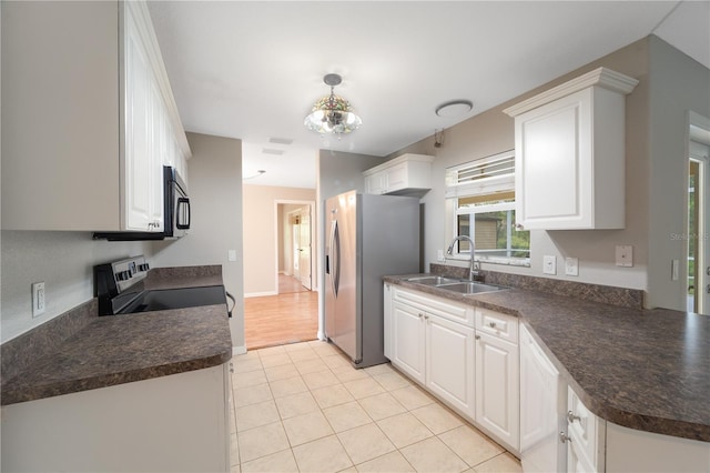 kitchen featuring light hardwood / wood-style flooring, pendant lighting, sink, white cabinets, and appliances with stainless steel finishes