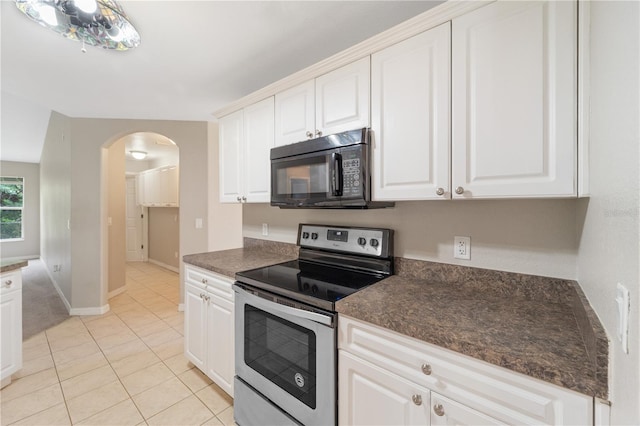 kitchen with white cabinetry, light tile flooring, and stainless steel range with electric cooktop