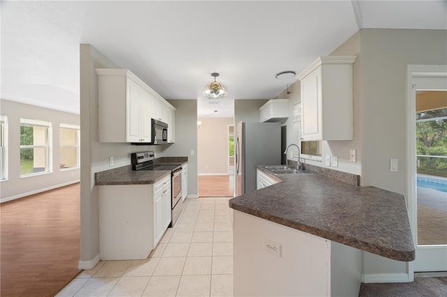 kitchen featuring stainless steel appliances, light hardwood / wood-style flooring, and white cabinetry