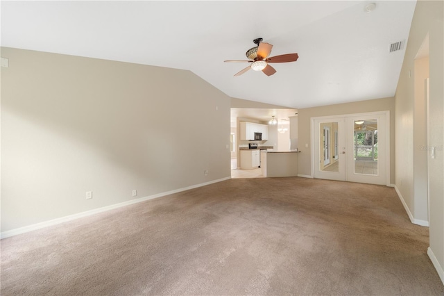 unfurnished living room featuring carpet, ceiling fan, french doors, and lofted ceiling