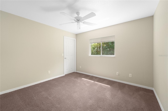 spare room featuring carpet and ceiling fan