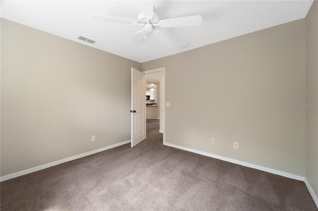 carpeted spare room with ceiling fan