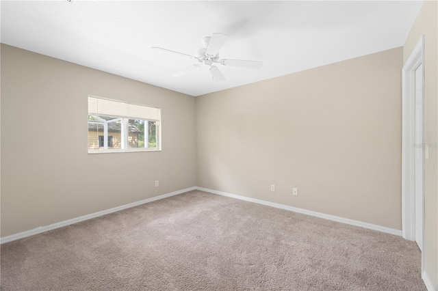 carpeted empty room featuring ceiling fan