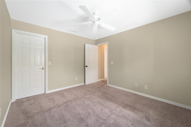 empty room with carpet and ceiling fan