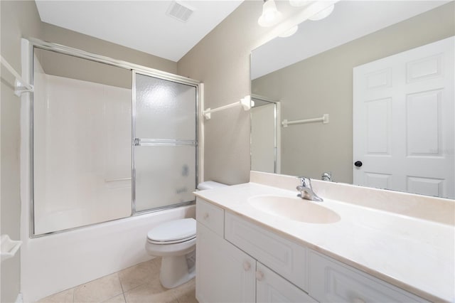 full bathroom with tile flooring, shower / bath combination with glass door, toilet, and large vanity