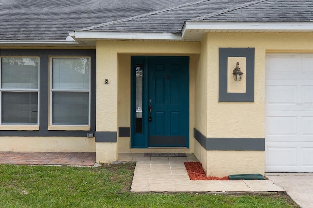 view of exterior entry with a garage