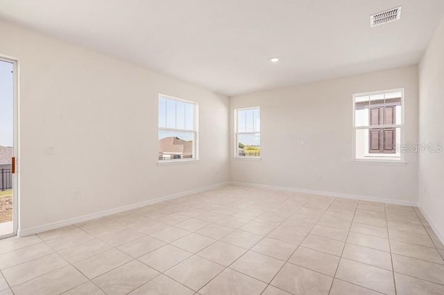 tiled spare room with a wealth of natural light