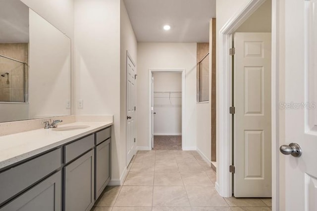 bathroom with walk in shower, tile floors, and large vanity