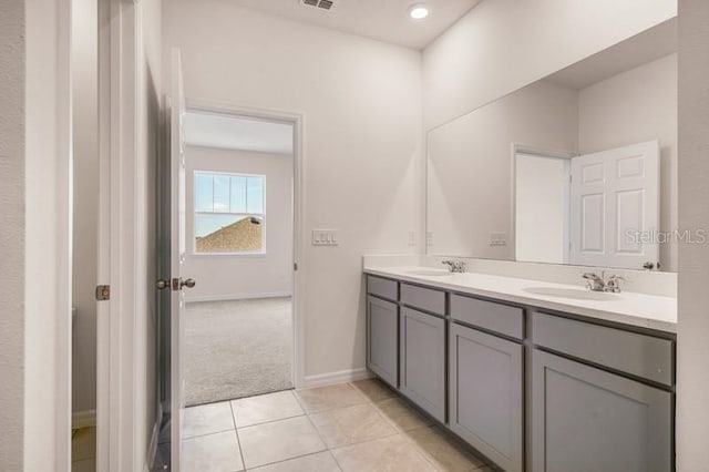 bathroom featuring tile flooring, large vanity, and double sink