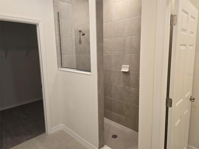 bathroom featuring tiled shower and tile floors