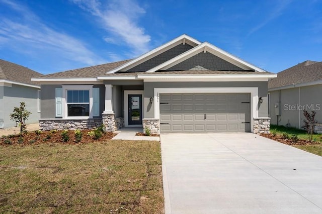 craftsman-style home with a front lawn and a garage