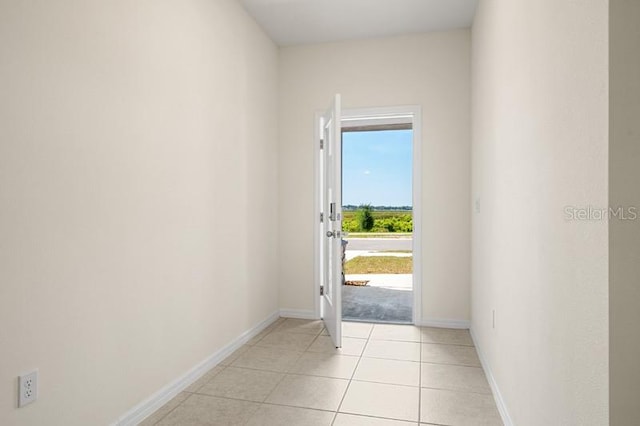 doorway to outside featuring light tile floors