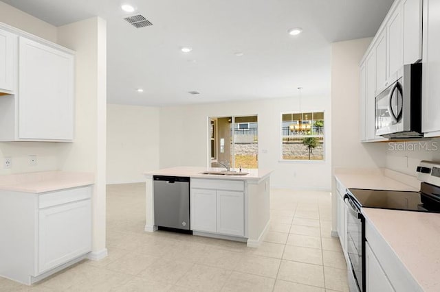 kitchen featuring stainless steel appliances, white cabinets, an island with sink, and light tile flooring