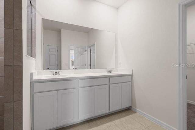 bathroom featuring double sink vanity and tile floors