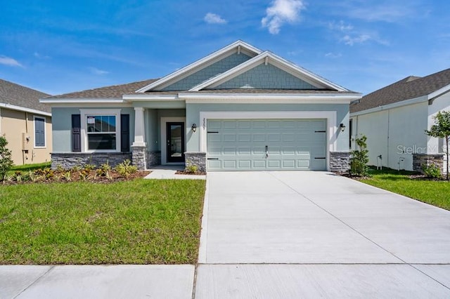 craftsman-style home featuring a garage and a front lawn