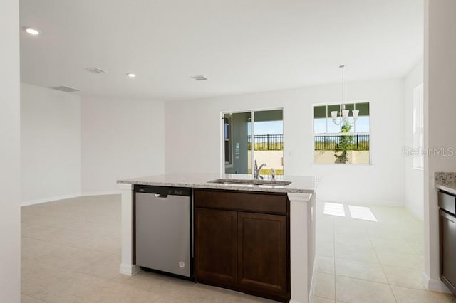 kitchen featuring decorative light fixtures, dishwasher, an island with sink, sink, and light tile floors