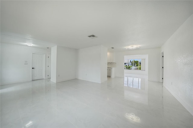 unfurnished room with light tile floors