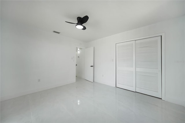 unfurnished bedroom with a closet, ceiling fan, and light tile floors