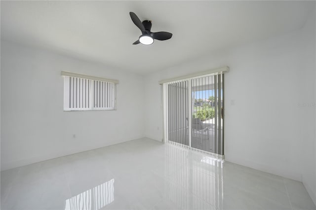 spare room with tile floors and ceiling fan