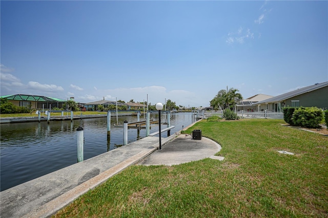 view of dock featuring a water view and a yard