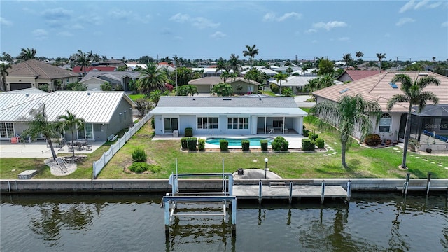 exterior space with a yard, a water view, and a patio area