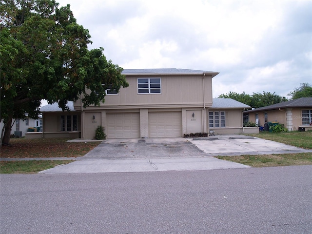 view of front of house featuring central AC and a garage