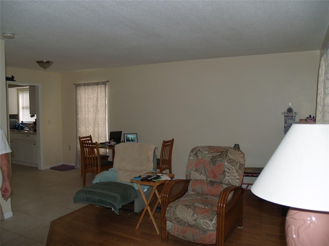 living room featuring a textured ceiling and tile floors