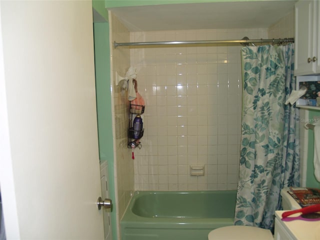 bathroom featuring shower / bath combination with curtain and toilet